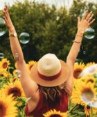 woman surrounded by sunflowers