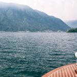 deck of boat on lake against high mountains