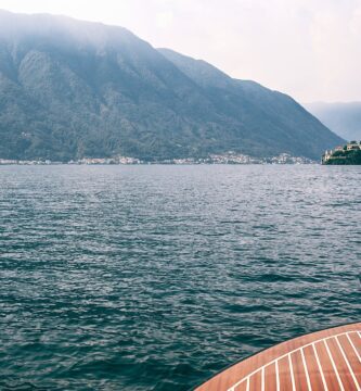 deck of boat on lake against high mountains