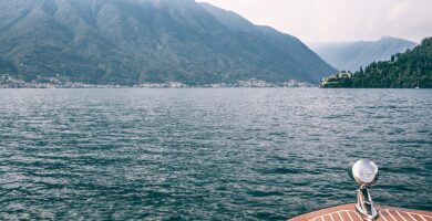 deck of boat on lake against high mountains