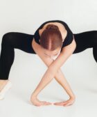 flexible woman doing yoga in studio