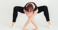 flexible woman doing yoga in studio