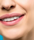 close up photo of woman with pink lipstick smiling