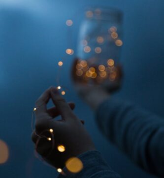 woman holding a yellow string light